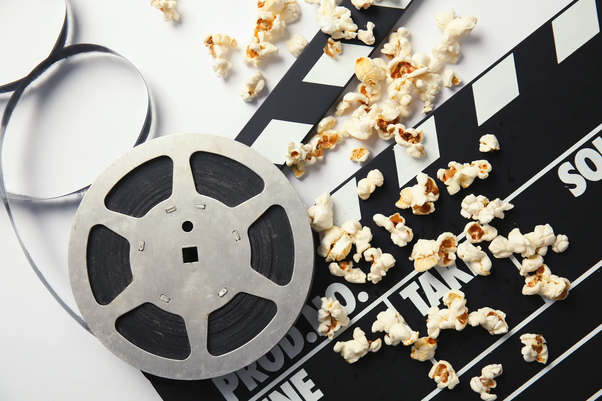Popcorn, film reel and clapperboard